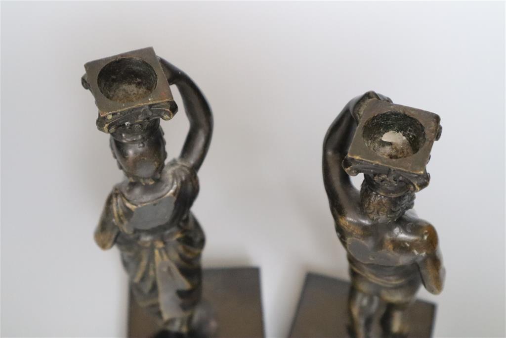 A pair of 19th century bronze figural candlesticks (once part of a clock), indistinctly stamped to reverse, overall height 23cm